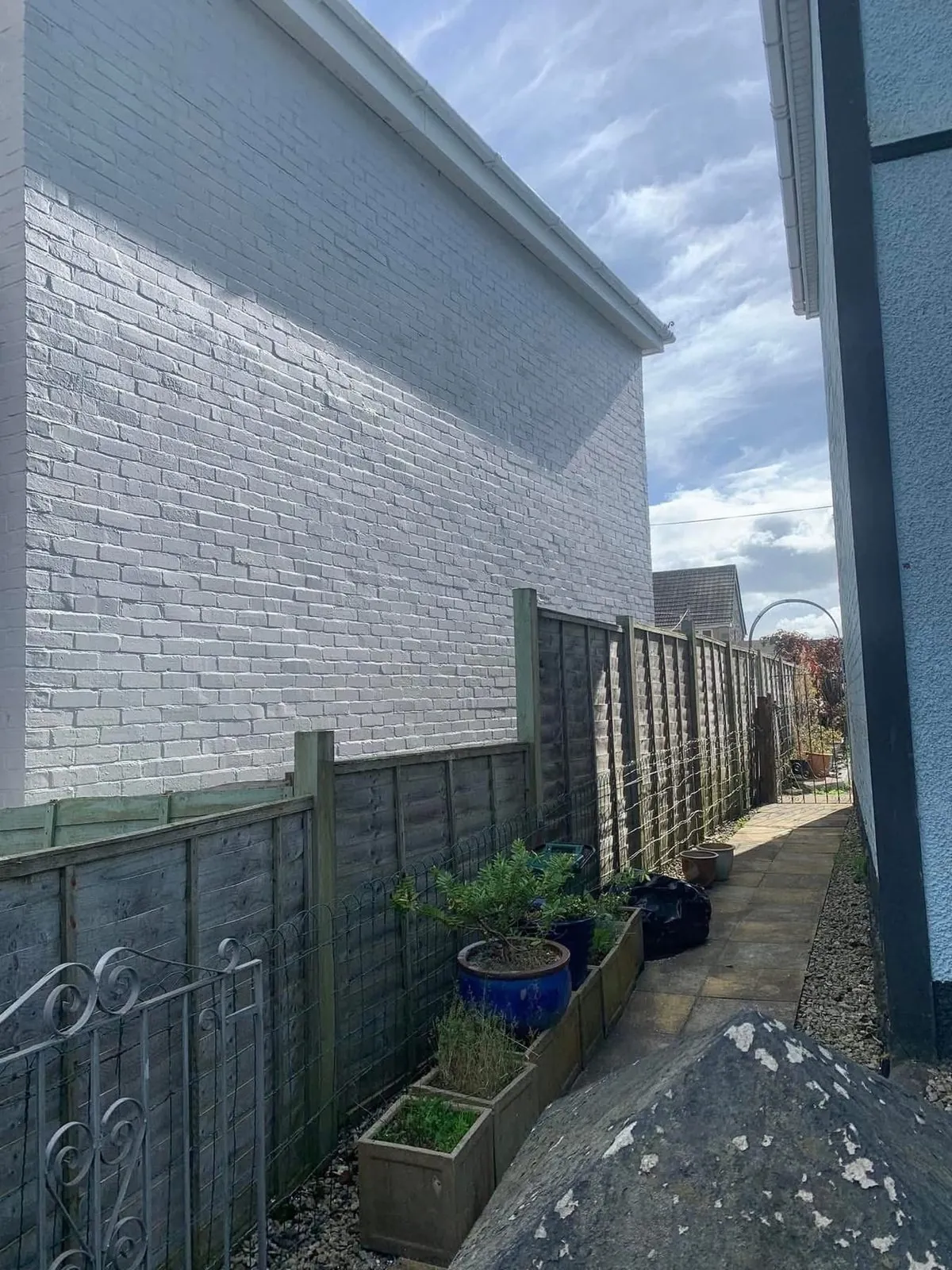 Freshly painted brick wall after preparation and masonry paint in Axminster